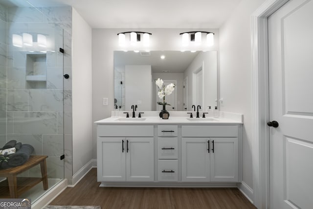 807 Stickley Oak Way, Woodstock, GA 30189 - bathroom with wood finished floors, a tile shower, and double vanity