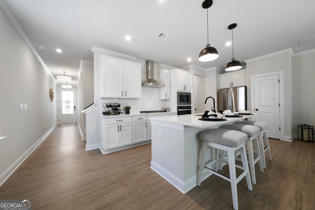 807 Stickley Oak Way, Woodstock, GA 30189 - kitchen featuring white cabinetry, stainless steel appliances, an island with sink, visible vents, and wall chimney exhaust hood