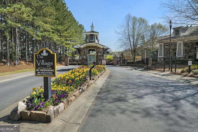 807 Stickley Oak Way, Woodstock, GA 30189 - view of street featuring sidewalks, a gated entry, street lighting, and curbs