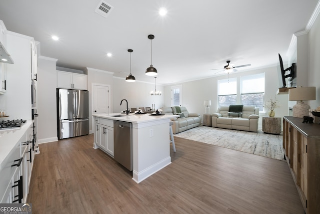807 Stickley Oak Way, Woodstock, GA 30189 - kitchen featuring stainless steel appliances, crown molding, ceiling fan, dark wood-type flooring, and white cabinetry