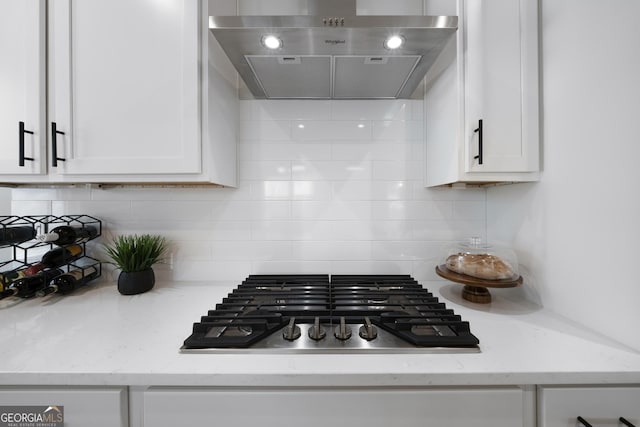 807 Stickley Oak Way, Woodstock, GA 30189 - kitchen with tasteful backsplash, under cabinet range hood, stainless steel gas stovetop, light stone counters, and white cabinets