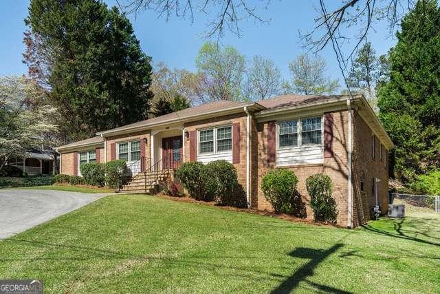 ranch-style house featuring a front lawn, fence, and brick siding