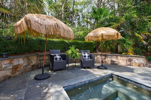 view of patio / terrace with a hot tub