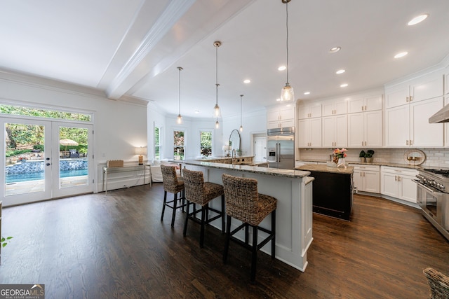 2005 Westbourne Way, Alpharetta, GA 30022 - kitchen featuring high quality appliances, a large island, healthy amount of natural light, beam ceiling, and french doors