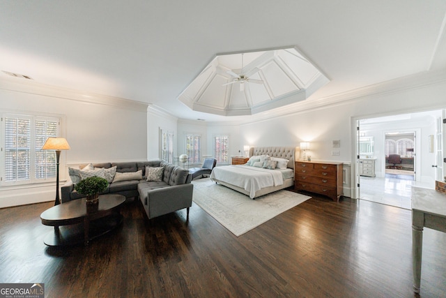 bedroom featuring crown molding, a raised ceiling, and dark wood-style floors