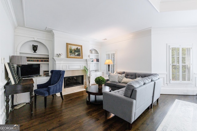 living area with ornamental molding, a fireplace, dark wood-style floors, and built in shelves