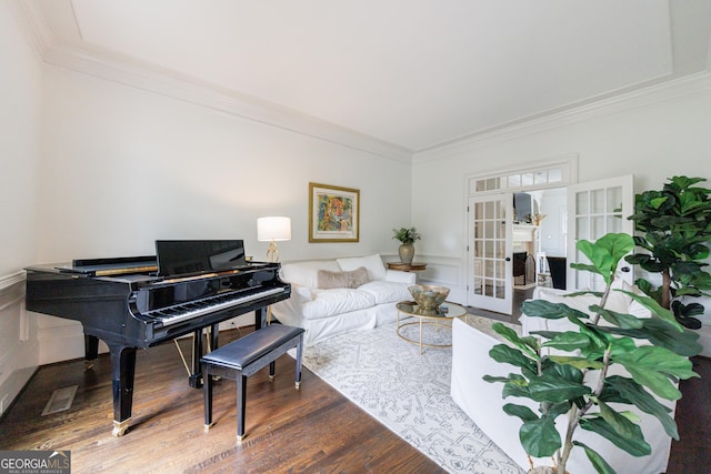 2005 Westbourne Way, Alpharetta, GA 30022 - living area featuring french doors, crown molding, wood finished floors, a wainscoted wall, and a decorative wall