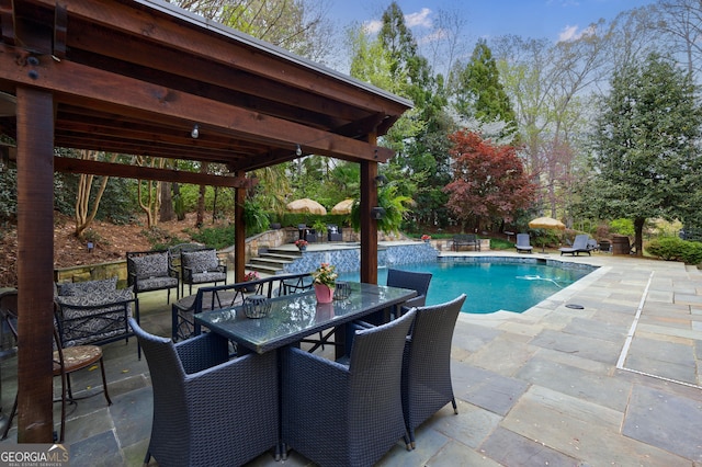 pool with stairway, a patio, and outdoor dining space