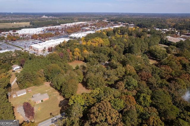drone / aerial view with a wooded view
