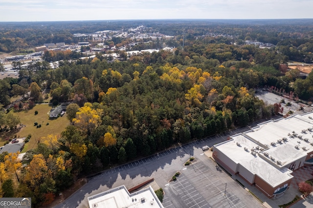 birds eye view of property with a view of trees