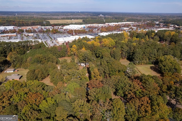 drone / aerial view featuring a wooded view
