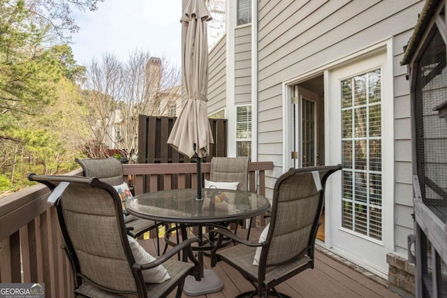 wooden terrace with outdoor dining area