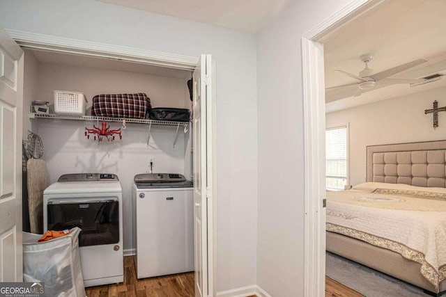 laundry room with a ceiling fan, wood finished floors, laundry area, visible vents, and washer and dryer