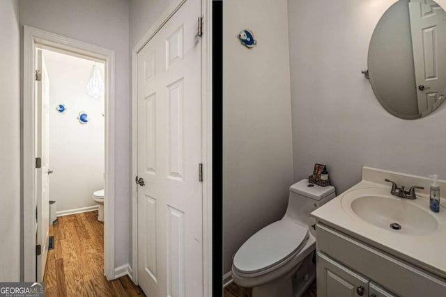 half bath with baseboards, toilet, vanity, and wood finished floors