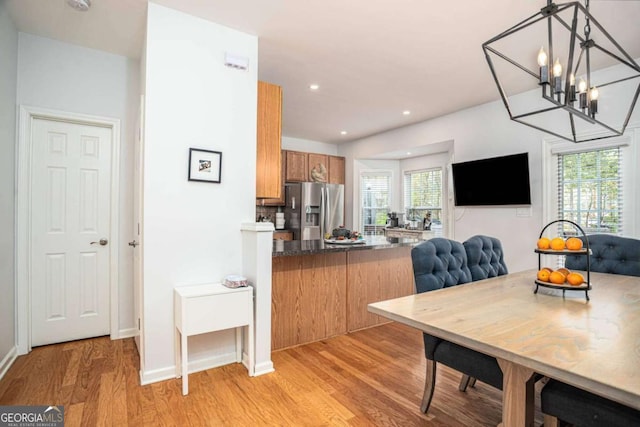 dining area featuring recessed lighting, baseboards, a chandelier, and light wood-type flooring