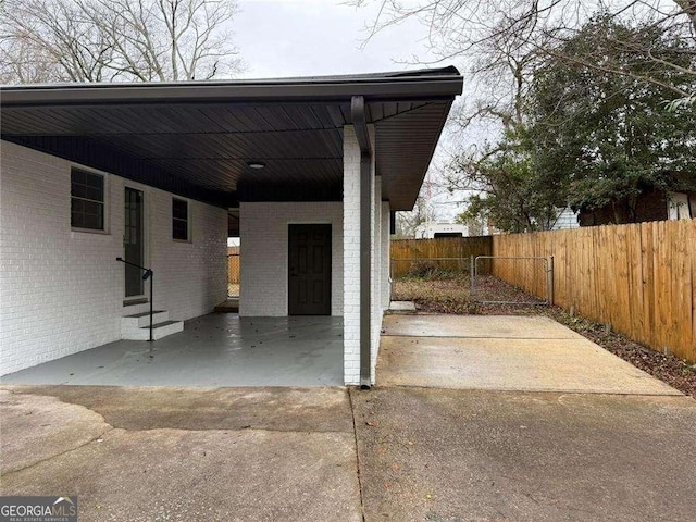 view of car parking featuring a carport and fence