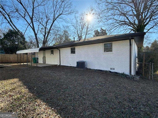 back of property featuring cooling unit, fence, brick siding, a patio, and crawl space