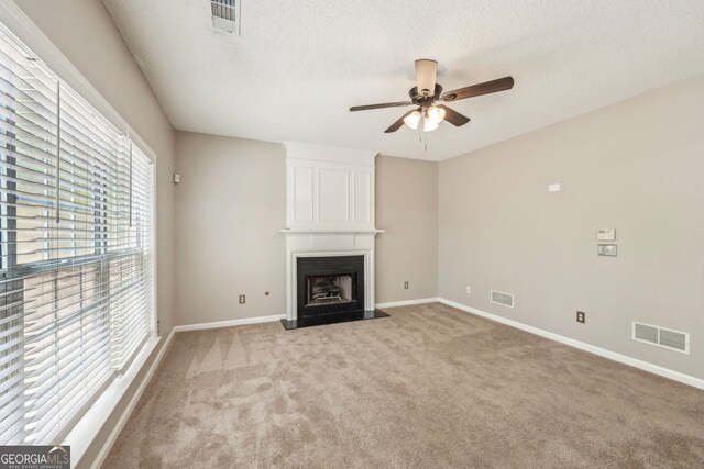 3936 Toccoa Falls Dr, Duluth, GA 30097 - unfurnished living room with ceiling fan, light carpet, a textured ceiling, baseboards, and a large fireplace