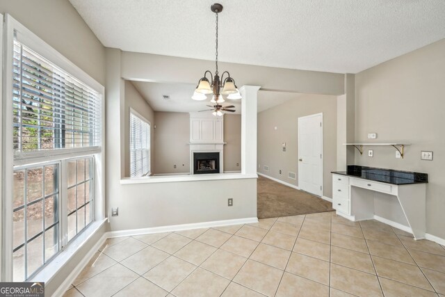 3936 Toccoa Falls Dr, Duluth, GA 30097 - unfurnished living room featuring a large fireplace, a chandelier, baseboards, light tile patterned floors, and a textured ceiling