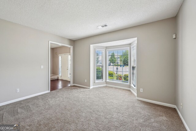 3936 Toccoa Falls Dr, Duluth, GA 30097 - unfurnished room featuring carpet, a textured ceiling, and baseboards