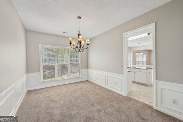 3936 Toccoa Falls Dr, Duluth, GA 30097 - spare room featuring a chandelier, light carpet, healthy amount of natural light, a decorative wall, and a wainscoted wall