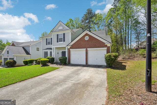 3936 Toccoa Falls Dr, Duluth, GA 30097 - traditional home with brick siding, an attached garage, a front yard, concrete driveway, and a chimney