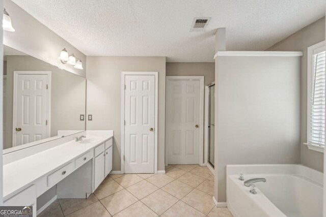 3936 Toccoa Falls Dr, Duluth, GA 30097 - full bath with vanity, a garden tub, tile patterned flooring, a stall shower, and a textured ceiling