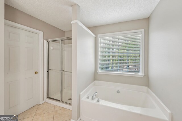 3936 Toccoa Falls Dr, Duluth, GA 30097 - bathroom with a bath, a shower stall, a textured ceiling, and tile patterned floors