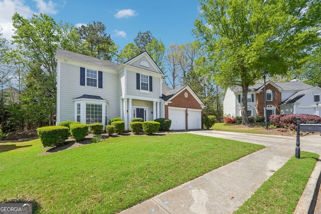 3936 Toccoa Falls Dr, Duluth, GA 30097 - view of front facade with concrete driveway and a front lawn