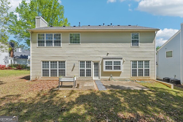 3936 Toccoa Falls Dr, Duluth, GA 30097 - back of house with a patio area, a chimney, a yard, and central AC