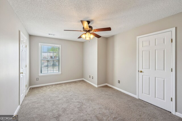 3936 Toccoa Falls Dr, Duluth, GA 30097 - unfurnished bedroom with carpet flooring, baseboards, a textured ceiling, and a ceiling fan