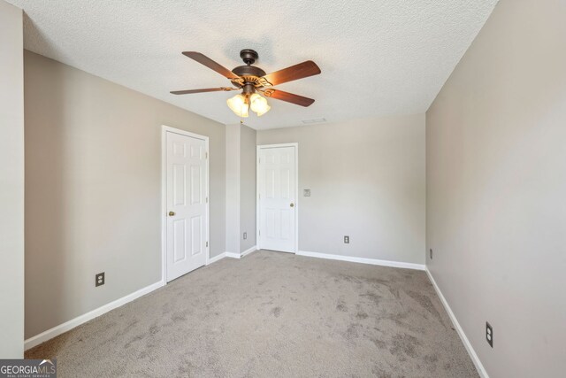 3936 Toccoa Falls Dr, Duluth, GA 30097 - unfurnished bedroom featuring carpet, baseboards, a textured ceiling, and a ceiling fan