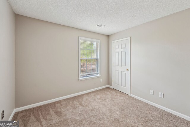 3936 Toccoa Falls Dr, Duluth, GA 30097 - empty room with carpet floors, a textured ceiling, and baseboards