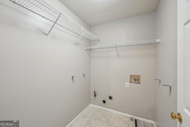 3936 Toccoa Falls Dr, Duluth, GA 30097 - laundry area with hookup for a washing machine, hookup for an electric dryer, light tile patterned flooring, baseboards, and hookup for a gas dryer
