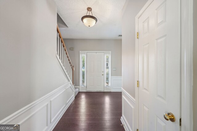 3936 Toccoa Falls Dr, Duluth, GA 30097 - entrance foyer featuring a decorative wall, a wainscoted wall, dark wood finished floors, stairs, and a textured ceiling