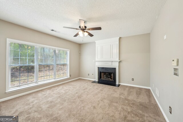 3936 Toccoa Falls Dr, Duluth, GA 30097 - unfurnished living room with ceiling fan, light carpet, a textured ceiling, a fireplace, and baseboards