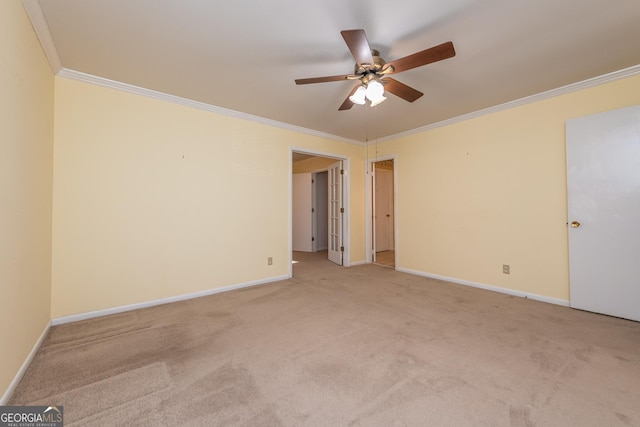 unfurnished room with a ceiling fan, light colored carpet, baseboards, and ornamental molding