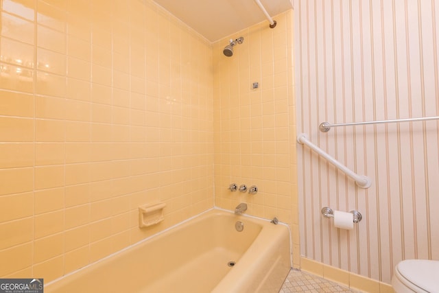 full bath featuring baseboards, wallpapered walls, tile patterned floors, shower / bath combination, and toilet