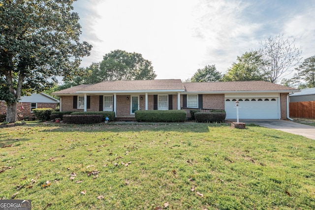 ranch-style home featuring concrete driveway, a front lawn, an attached garage, brick siding, and fence