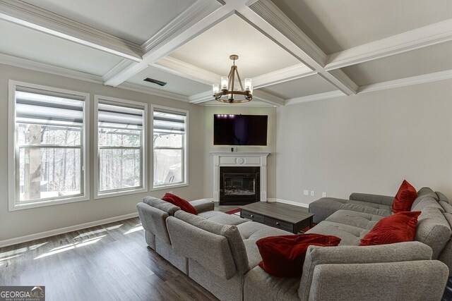 living area with coffered ceiling, dark wood-style floors, baseboards, and a chandelier