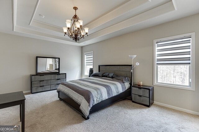 bedroom featuring baseboards, an inviting chandelier, carpet, and a raised ceiling