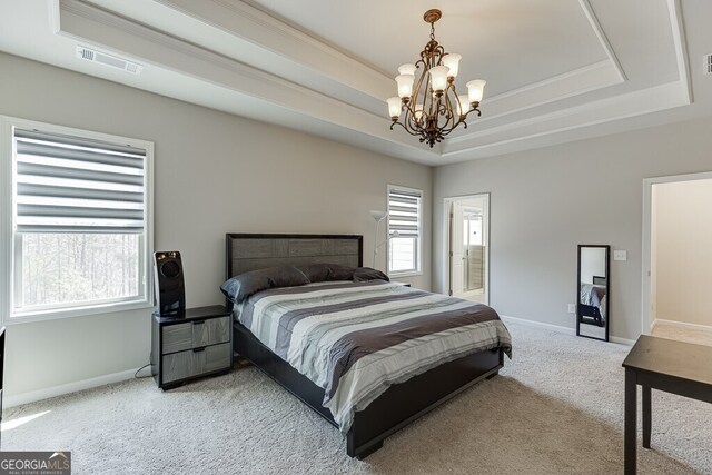 bedroom with carpet flooring, visible vents, a chandelier, baseboards, and a tray ceiling