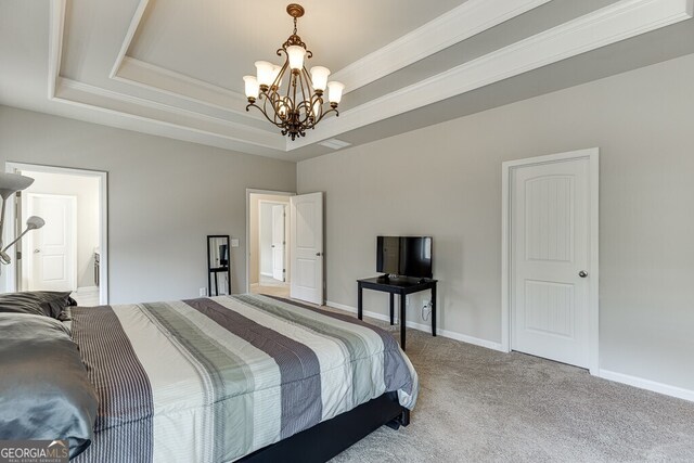 bedroom with a tray ceiling, carpet floors, a chandelier, baseboards, and ornamental molding