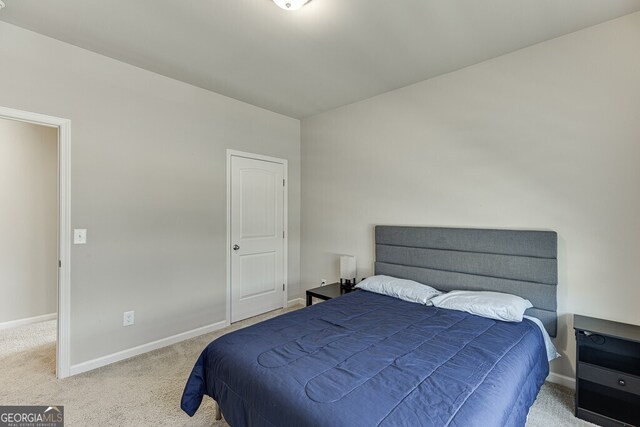 carpeted bedroom featuring baseboards