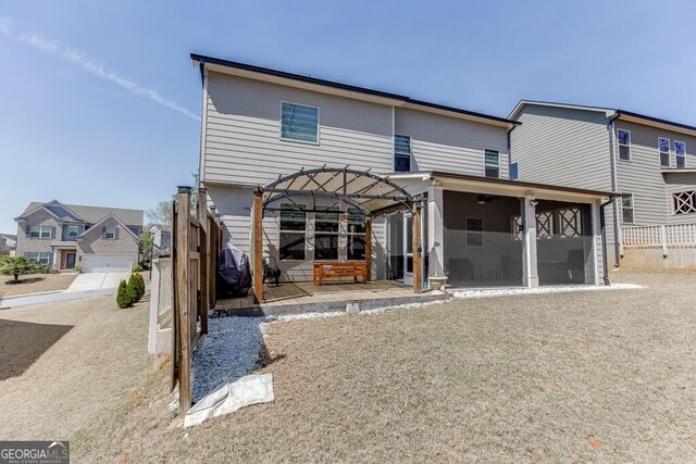 rear view of property with a patio and a sunroom
