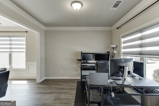 home office featuring baseboards, visible vents, ornamental molding, and wood finished floors