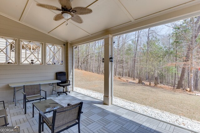 sunroom featuring a ceiling fan and a wealth of natural light