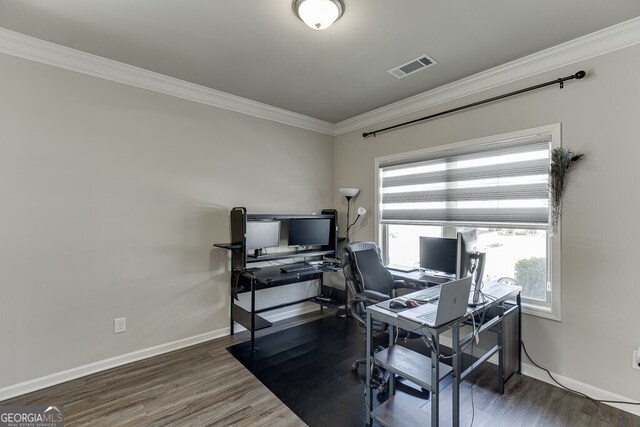 home office with visible vents, wood finished floors, and ornamental molding