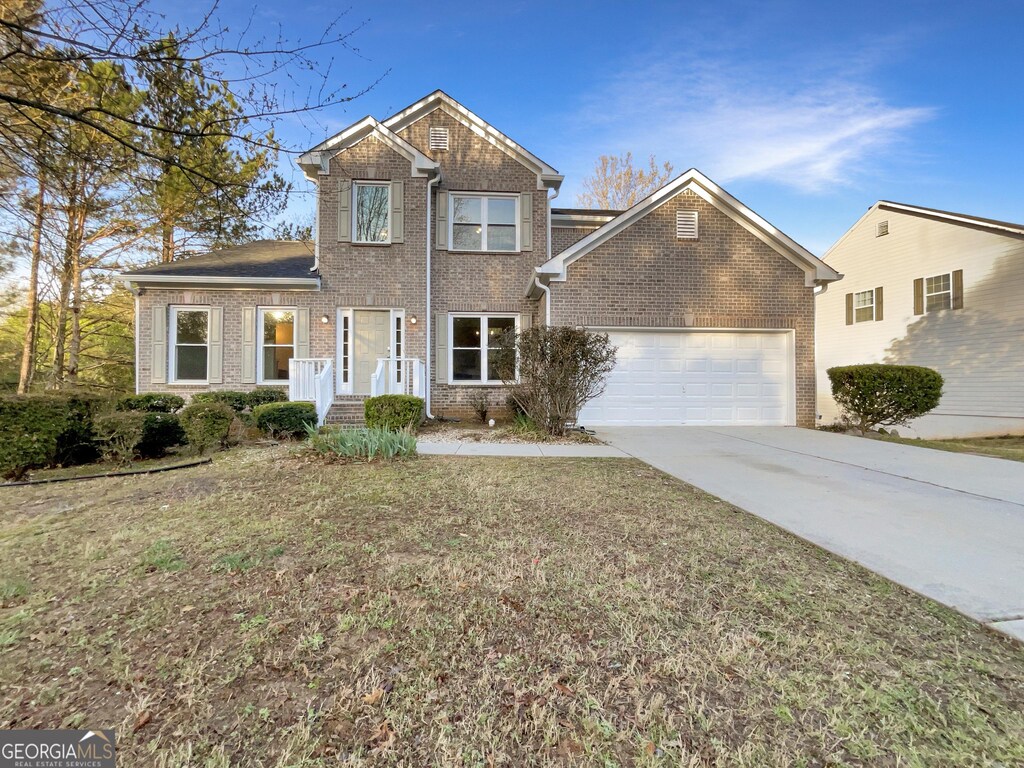 3110 Cambrian Ter, Austell, GA 30106 - traditional home with brick siding, driveway, a front lawn, and an attached garage