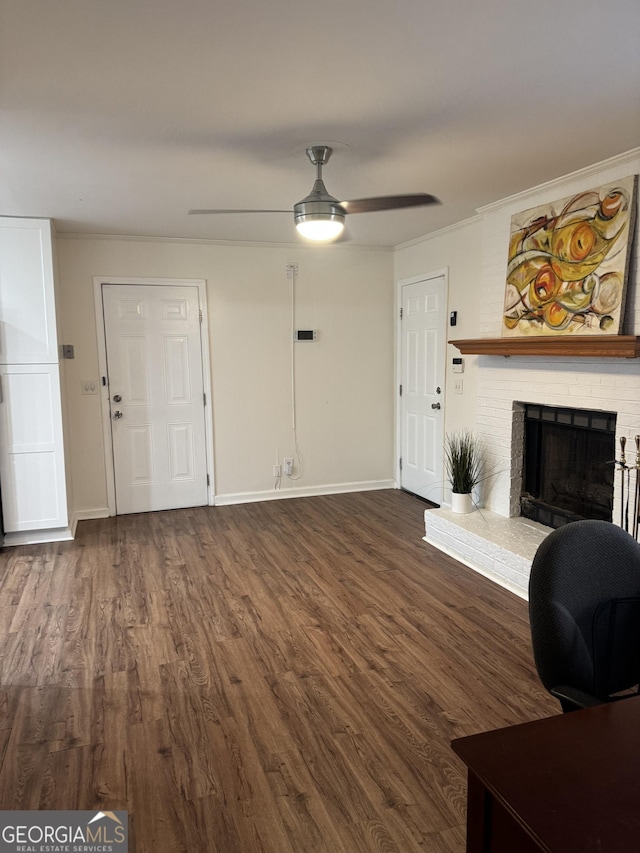 2791 Biscayne Dr, Conyers, GA 30012 - living area featuring baseboards, dark wood-style flooring, a fireplace, and a ceiling fan